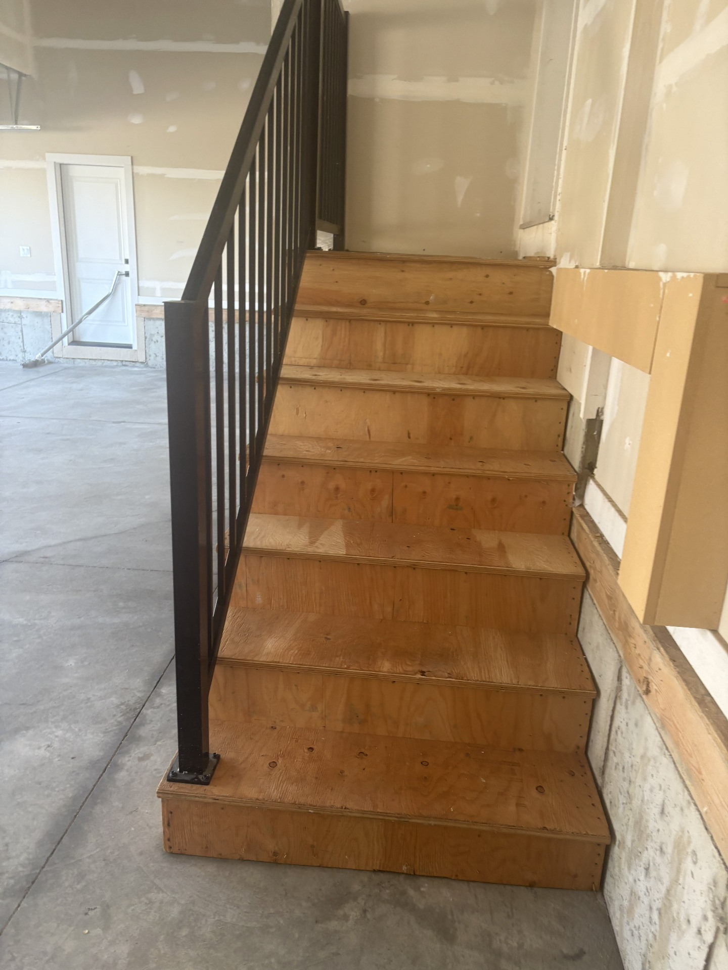 Plywood stairs in garage before epoxy coating